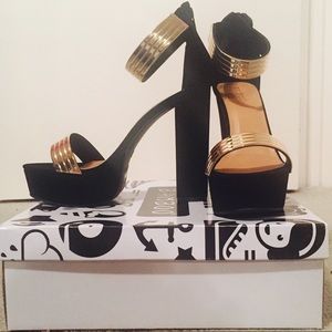 Black high heel shoes with gold ankle strap